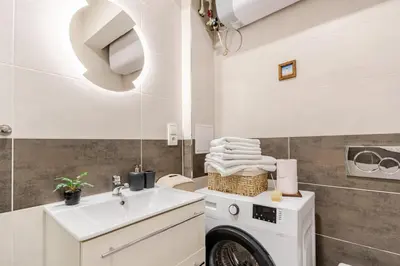 a bathroom with a washing machine and a sink at Charm Apartment Deco near Old Town, All-Friendly in Prague