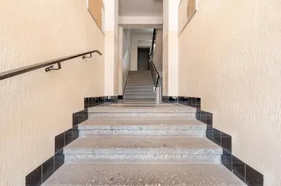 a set of stairs in a building with black tiles at Charm Apartment Deco near Old Town, All-Friendly in Prague