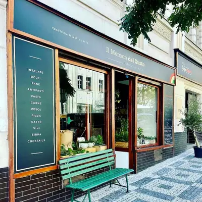 a green bench sitting outside of a store window at Charm Apartment Deco near Old Town, All-Friendly in Prague