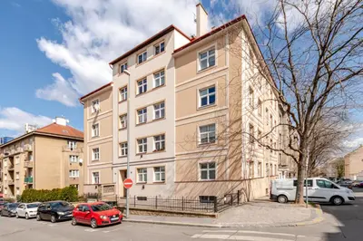 a large building with cars parked in front of it at Charm Apartment Deco near Old Town, All-Friendly in Prague