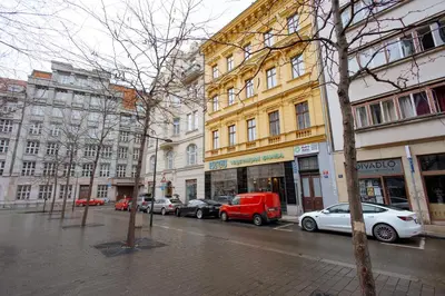 a city street with cars parked in front of buildings at Charming Duplex Loft in Prague Center in Prague