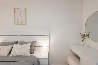 a bedroom with a bed and a desk with a mirror at Charming Duplex Loft in Prague Center in Prague