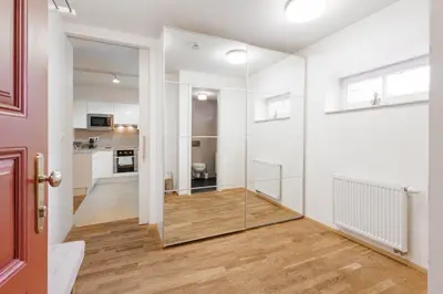 a room with white walls and a glass wall at Charming Duplex Loft in Prague Center in Prague