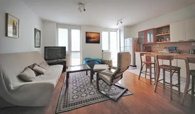 a living room with a couch and a kitchen at Pleasant apartment close to city center in Prague