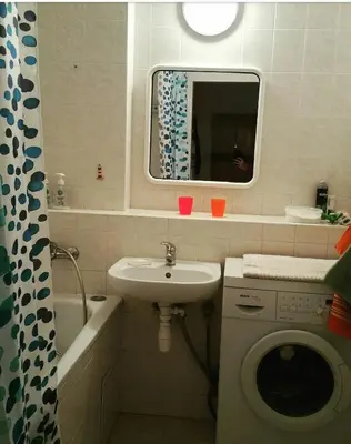 a bathroom with a sink and a washing machine at Pleasant apartment close to city center in Prague