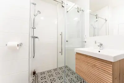 a bathroom with a sink and a shower at Oomph Apartments in Prague