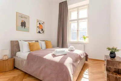 a bedroom with a bed with two towels on it at Oomph Apartments in Prague