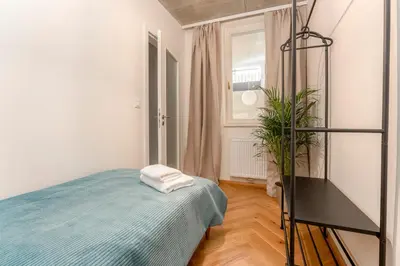 a bedroom with a bed and a plant in it at Oomph Apartments in Prague