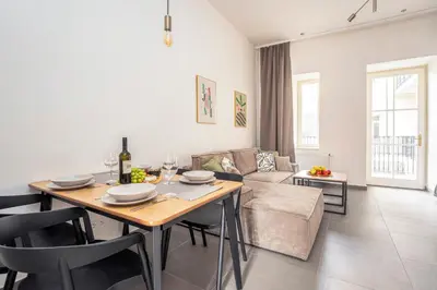 a living room with a table and a couch at Oomph Apartments in Prague