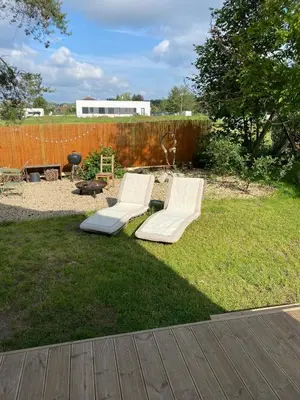 a backyard with a bench and a fence at Cottage by the Jizera river in Nový Vestec