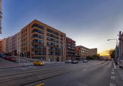 a city street with cars parked in front of a building at Viktoria Suite N6 with Garage & Balcony in Prague