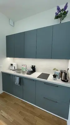 a kitchen with blue cabinets and a counter top at Viktoria Suite N6 with Garage & Balcony in Prague