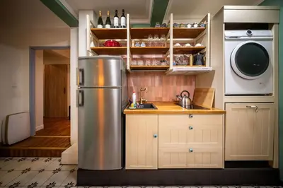 a kitchen with a refrigerator and a washer and dryer at PilotsApartments in Prague