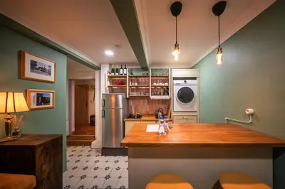 a kitchen with green walls and a counter top at PilotsApartments in Prague