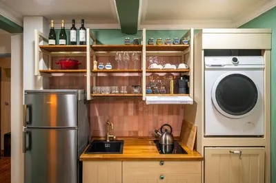 a kitchen with a refrigerator and a washing machine at PilotsApartments in Prague