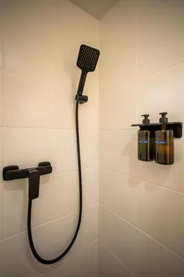 a shower with a shower head in a bathroom at PilotsApartments in Prague