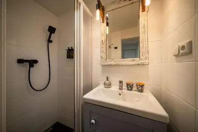 a bathroom with a sink and a mirror at PilotsApartments in Prague