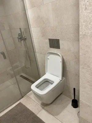 a bathroom with a toilet and a shower at Peaceful Escape & Cozy Backyard in Prague