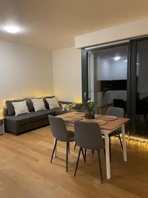 a living room with a table and a couch at Peaceful Escape & Cozy Backyard in Prague