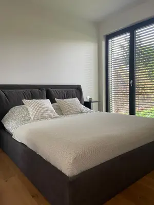 a large bed in a room with a window at Peaceful Escape & Cozy Backyard in Prague