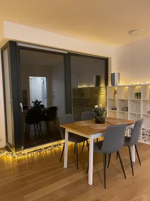 a dining room with a wooden table and chairs at Peaceful Escape & Cozy Backyard in Prague