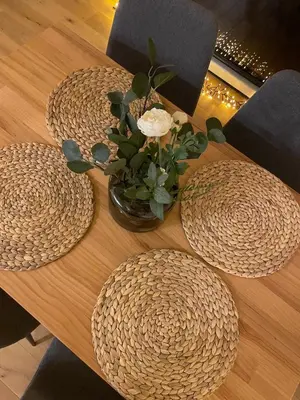 a wooden table with three plates and a vase with flowers at Peaceful Escape & Cozy Backyard in Prague