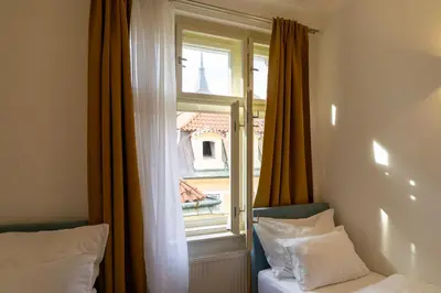 a bedroom with a window with a view of a building at Michalská Residence by Old Town Square in Prague