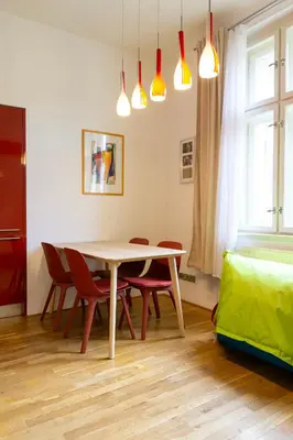 a dining room with a table and chairs and lights at Michalská Residence by Old Town Square in Prague