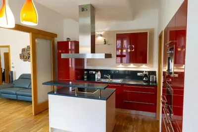 a kitchen with red cabinets and a counter top at Michalská Residence by Old Town Square in Prague