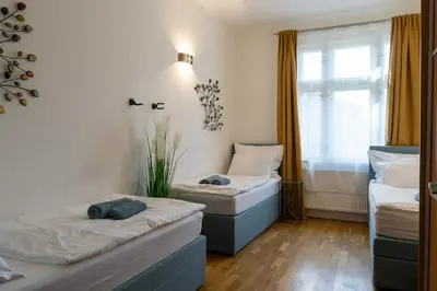 two beds in a room with a window at Michalská Residence by Old Town Square in Prague