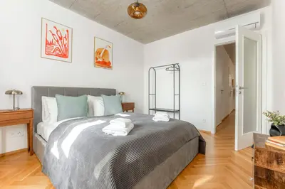 a bedroom with a large bed with towels on it at Visit Oomph Apartments in Prague