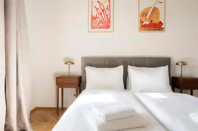 a bedroom with a bed with two towels on it at Visit Oomph Apartments in Prague