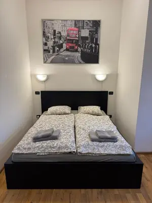 a bedroom with a bed and a red double decker bus at Cosy Studio with terrace near Florenc in Prague