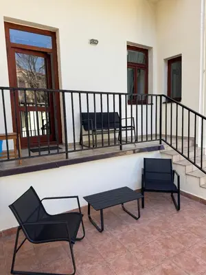 two chairs and a table on a balcony at Cosy Studio with terrace near Florenc in Prague