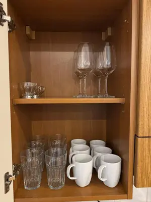 a cupboard with wine glasses and cups on it at Cosy Studio with terrace near Florenc in Prague