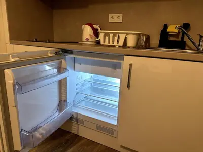 a refrigerator with its door open in a kitchen at Florenc Apartment in Prague
