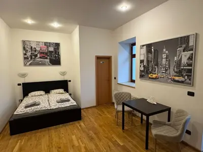 a bedroom with a bed and a table in it at Studio - Sleeps 2 -Smoking on balcony - Pets -Wifi in Prague