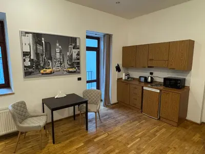 a kitchen with a table and chairs in a room at Studio - Sleeps 2 -Smoking on balcony - Pets -Wifi in Prague