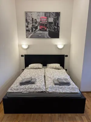 a bedroom with a bed and a red double decker bus at Studio - Sleeps 2 -Smoking on balcony - Pets -Wifi in Prague