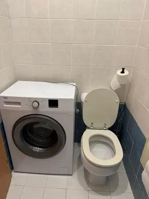 a bathroom with a washing machine and a toilet at Studio - Sleeps 2 -Smoking on balcony - Pets -Wifi in Prague