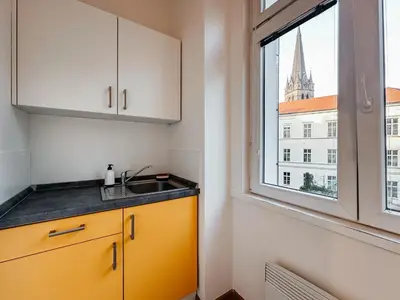 a kitchen with a sink and a window at SOEL apartments in Prague