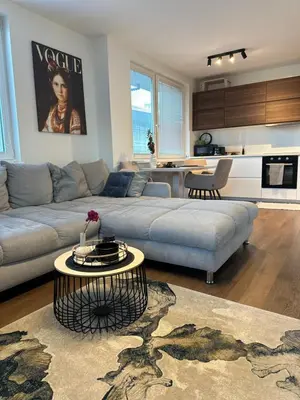 a living room with a couch and a table at Apartamenty Liben O2 in Prague