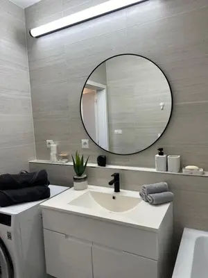 a bathroom with a sink and a mirror at Apartamenty Liben O2 in Prague
