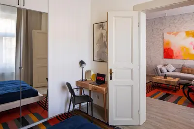 a room with a bed and a desk with a chair at Spectrum Apartment in Prague