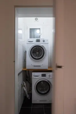 a washer and dryer in a small room at Spectrum Apartment in Prague