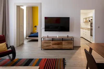 a living room with a flat screen tv on a wall at Spectrum Apartment in Prague