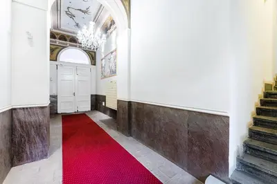 a red carpet in a hallway with a red rug at Rentero Charles square studio apartment Parking on request in Prague