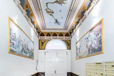 a room with paintings on the ceilings and a white door at Rentero Charles square studio apartment Parking on request in Prague