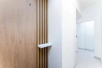 a bathroom with a wooden door with a handle at Rentero Charles square studio apartment Parking on request in Prague