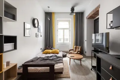 a bedroom with a bed and a table in a room at Urban Wave Apartment in Prague